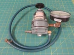 Nullmatic 40-100 Pressure Regulator Assembly W/ Attached Gauge And Air Hose. Fixed Price $195.00.